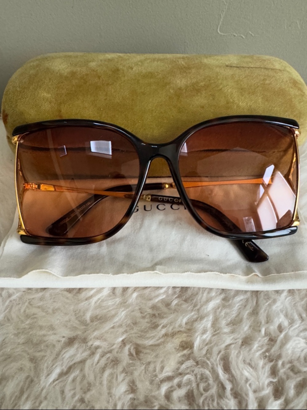 These are Gucci GG0592S 003 Havana/Gold sunglasses with butterfly accents